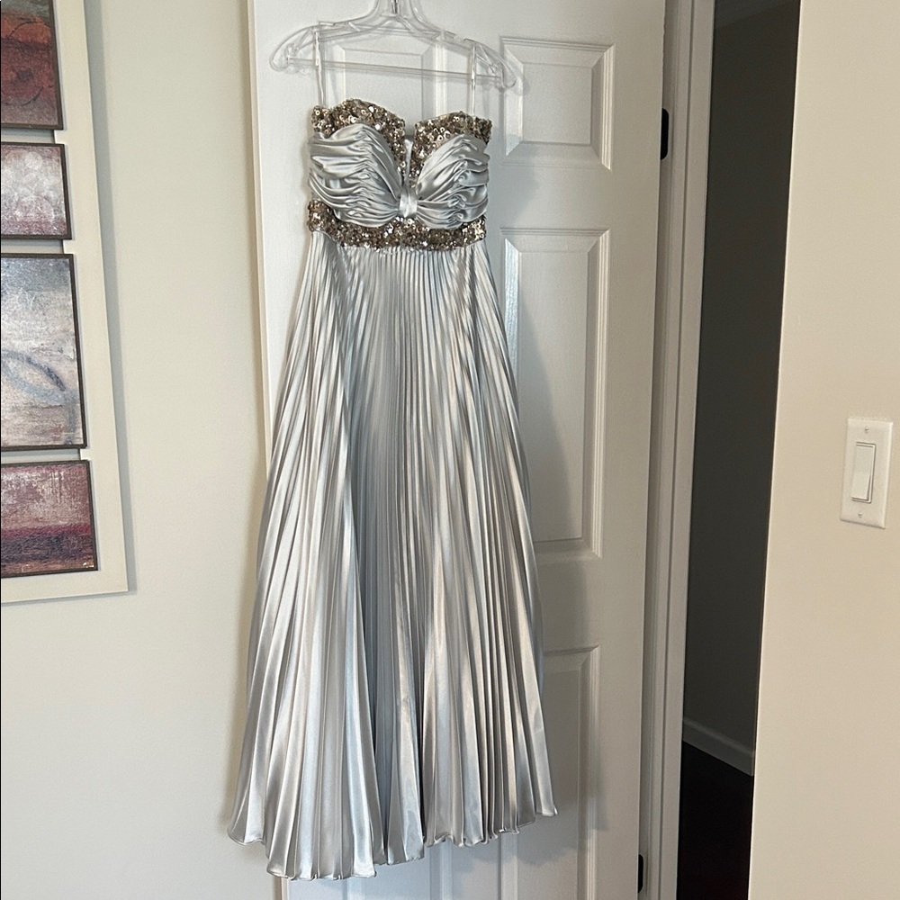 This never worn strapless satin silver gown very elegant